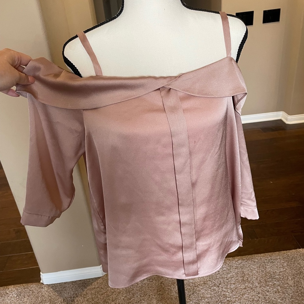 Champagne/pink blouse with tank top straps, long sleeves and open should area.